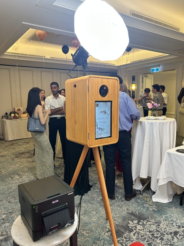 Photo booth with large light and touchscreen for fun event photos.