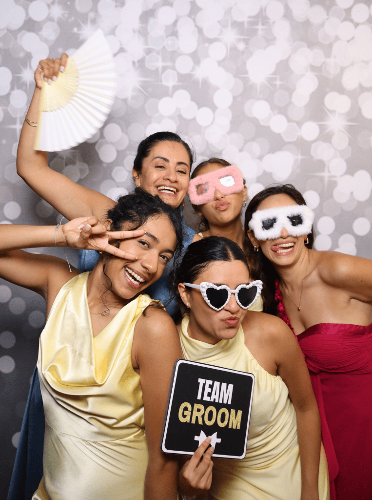 Group of 5 people wearing glasses and props at a photobooth wedding in Sydney